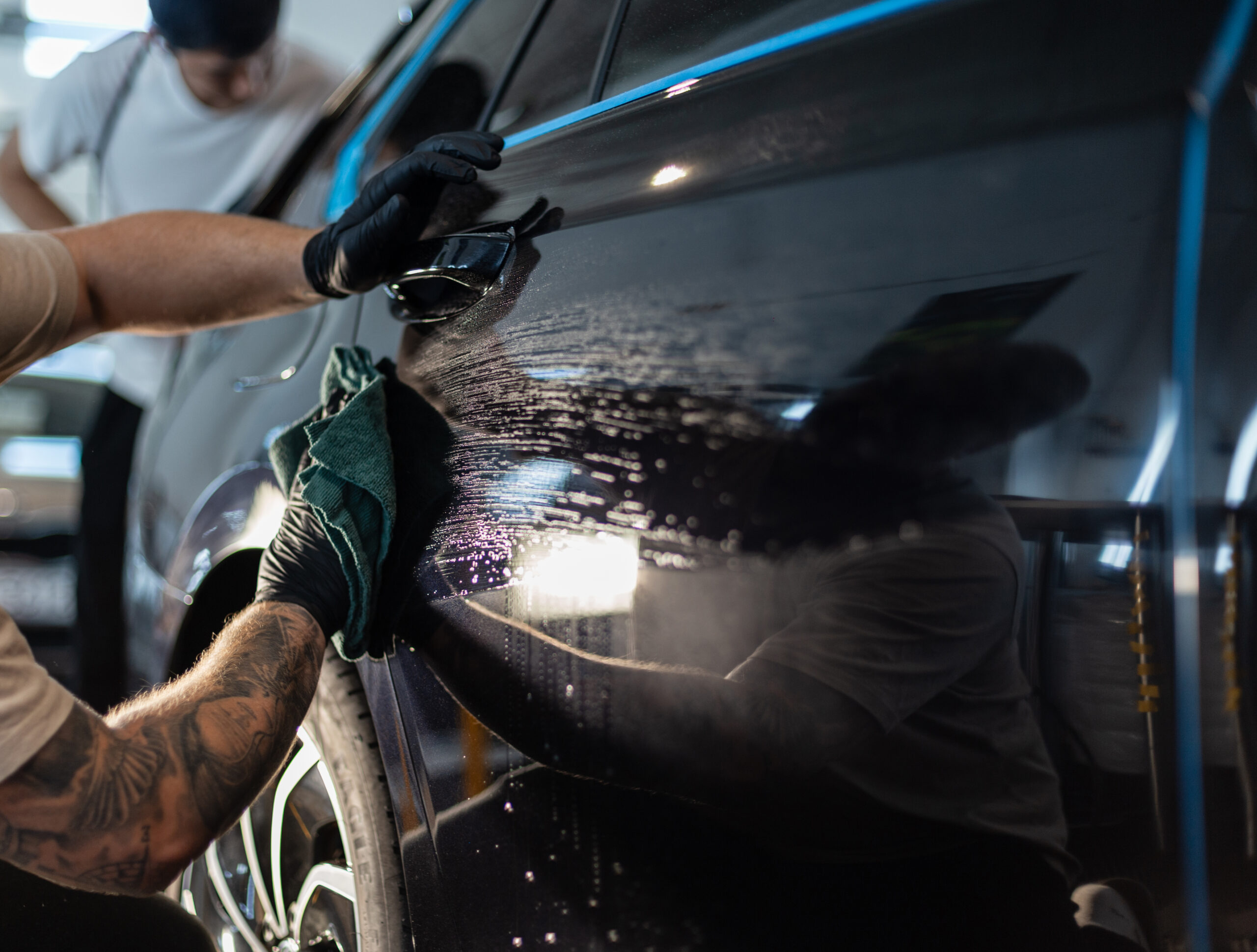 Close‑up of water beading on ceramic coated vehicle paint surface.