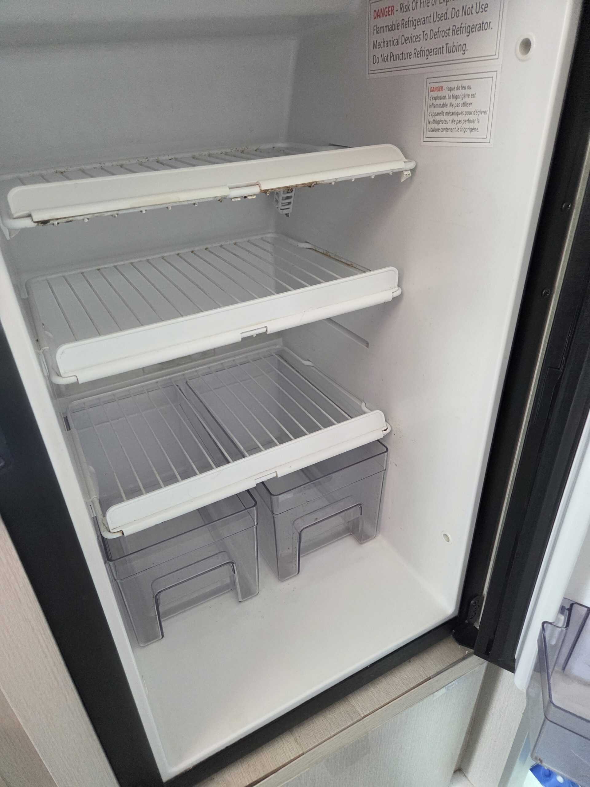 Close‑up of RV storage compartment interior cleaned and organized after detailing.